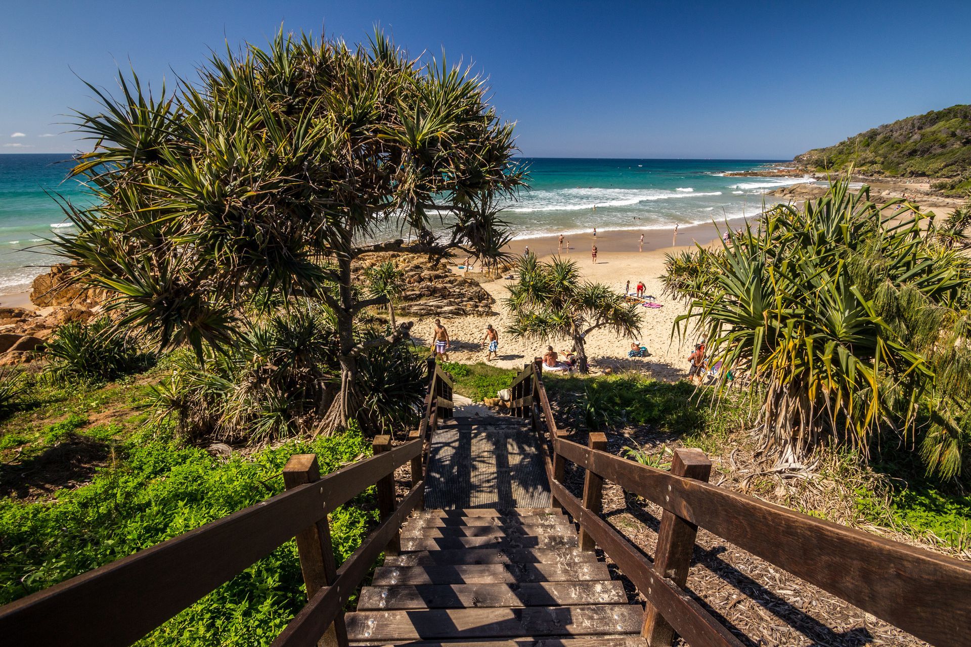 Wooden Stairs Leading Down To A Sunny Beach With People — Ace Fridge Door Seals In Port Douglas, QLD