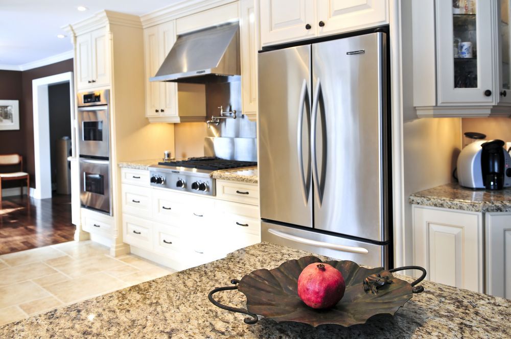 Modern Kitchen With Stainless Steel Appliances And Granite Countertops — Ace Fridge Door Seals in Mareeba, QLD