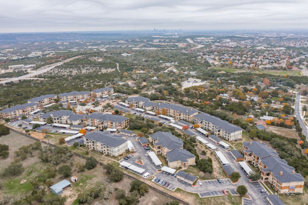 Aerial view of a large apartment community with multiple buildings and parking lots.