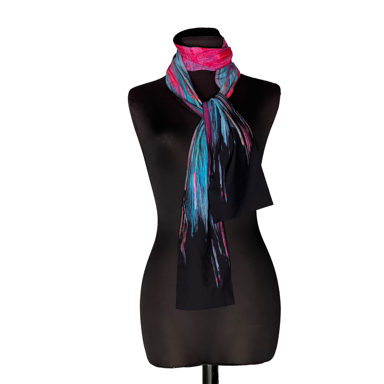 Black mannequin wearing a black top and a bright pink, blue, and black scarf
