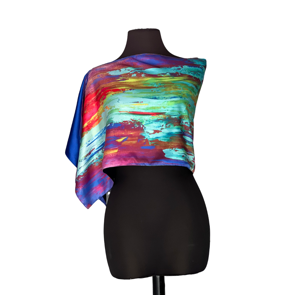 Colorful abstract print silk scarf draped over a black mannequin.