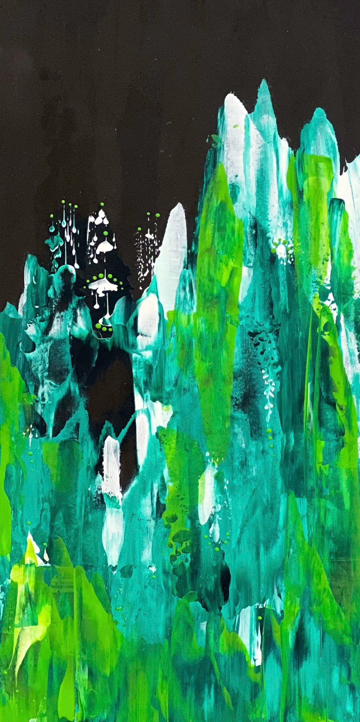 Mannequin wearing a green, blue, and teal abstract-patterned shawl draped over one shoulder