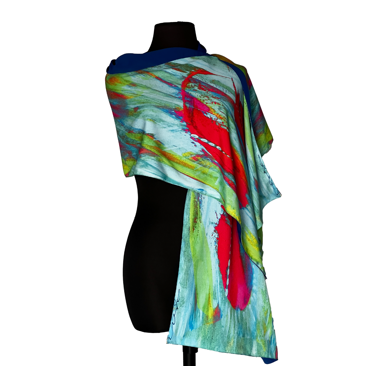 Abstract-patterned scarf draped over a black mannequin, featuring blue, red, and green brushstrokes.
