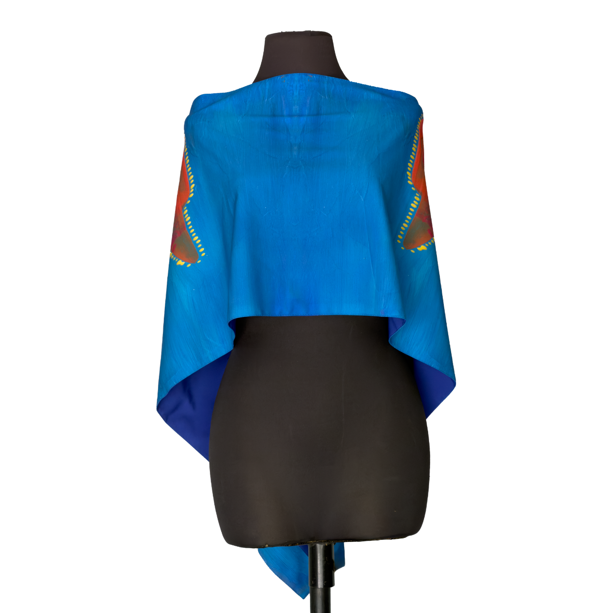 Blue draped garment with multicolored sleeves on a dress form against a white background