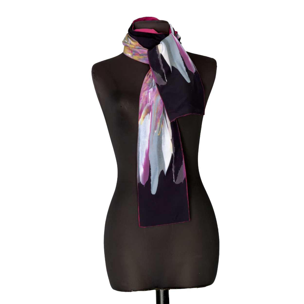Black mannequin displaying a long dark scarf with pink, white, and pastel accents