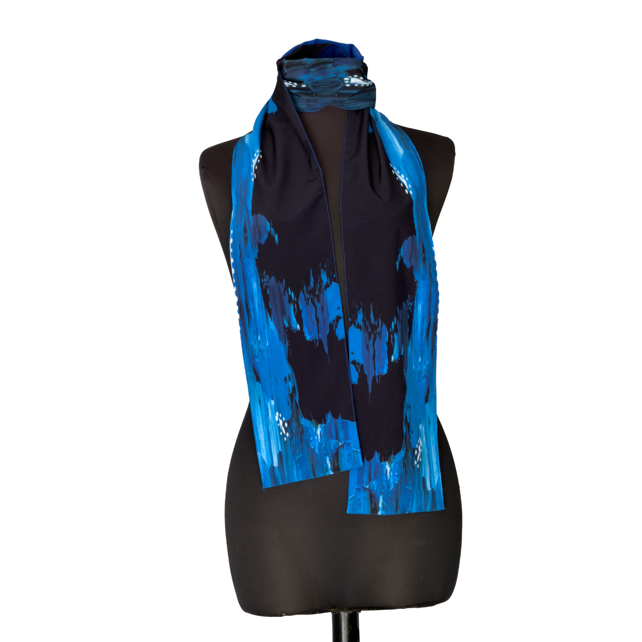 Blue and black patterned scarf draped over a black mannequin torso on a white background