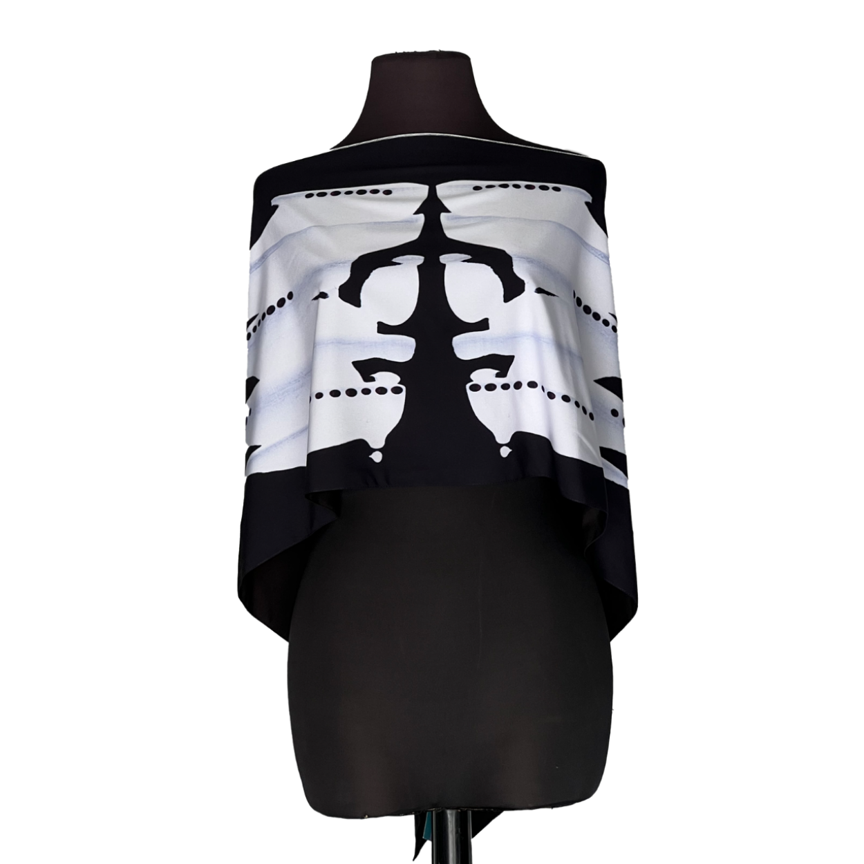 Black-and-white abstract off-shoulder top on a mannequin with bold symmetrical pattern