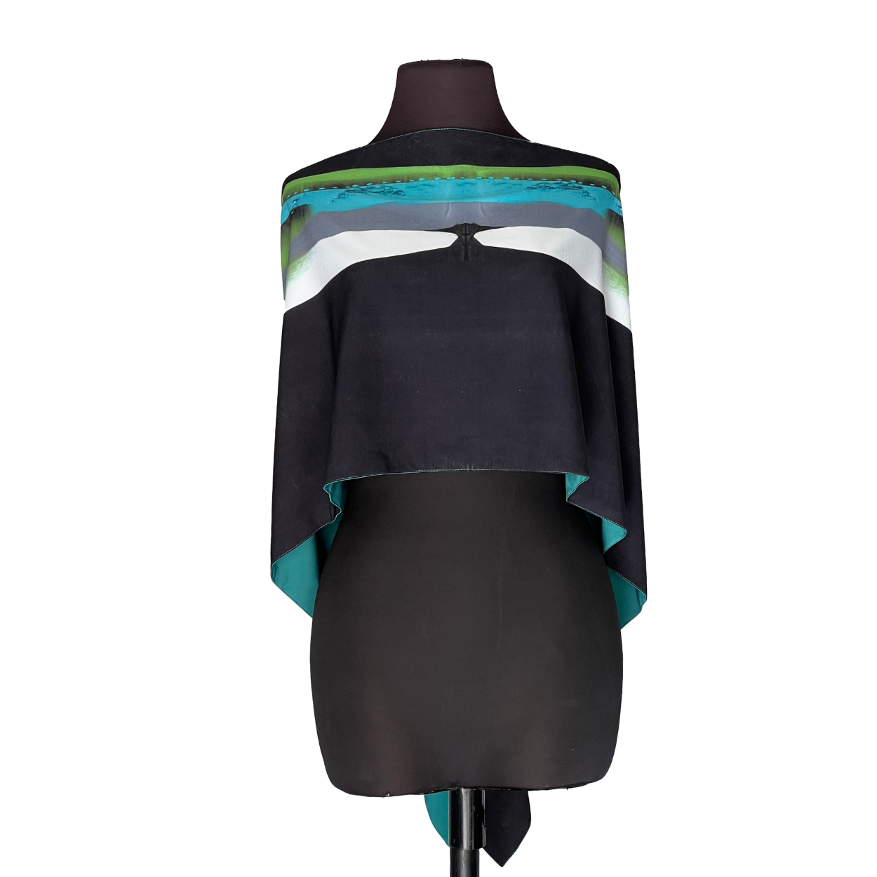 Black mannequin wearing a draped sleeveless top with teal, white, and blue stripes