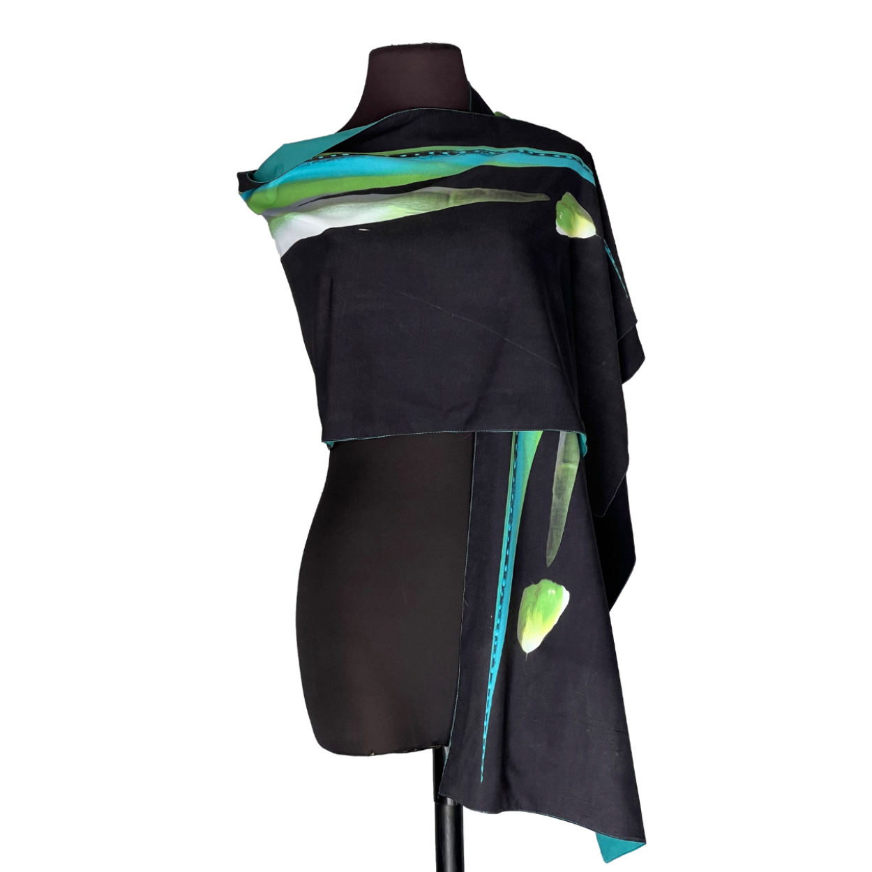 Black dress with colorful teal and green draped accents on a mannequin