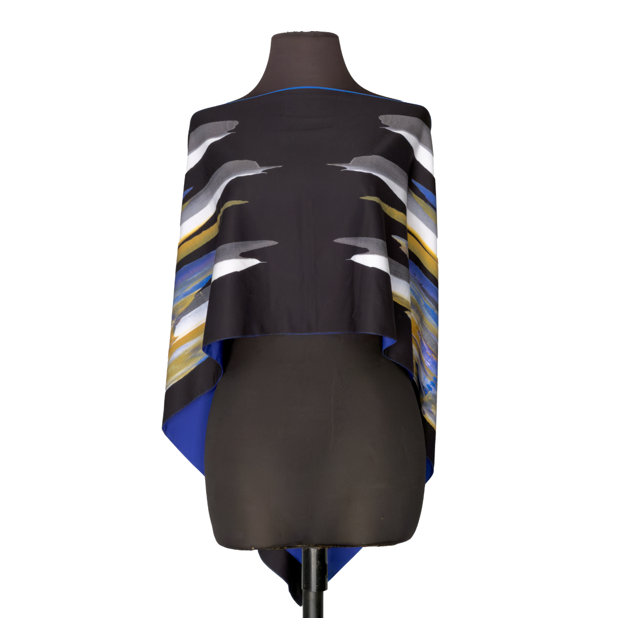 Black mannequin wearing a draped abstract patterned garment with white, blue, and gold accents