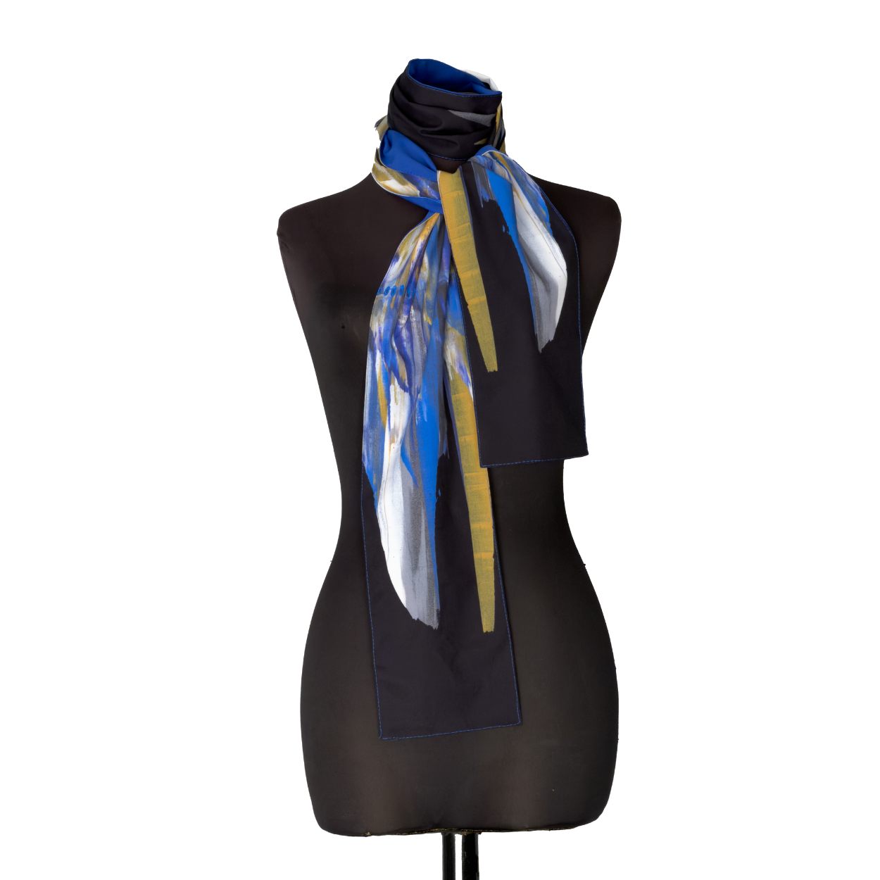 Black dress form wearing a blue-and-white patterned scarf on a dark background