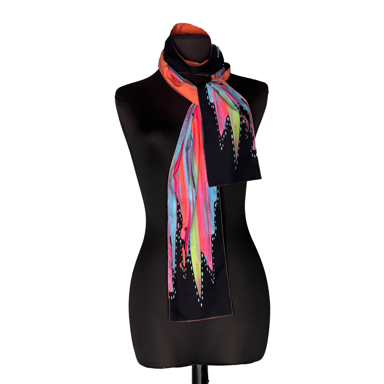 Black mannequin wearing a colorful striped scarf on a plain white background