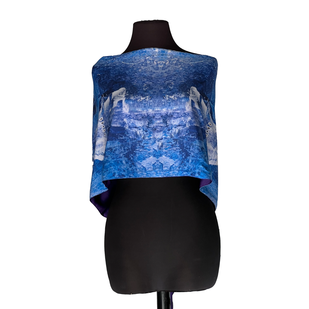Blue patterned off-the-shoulder top on a black mannequin torso against a white background