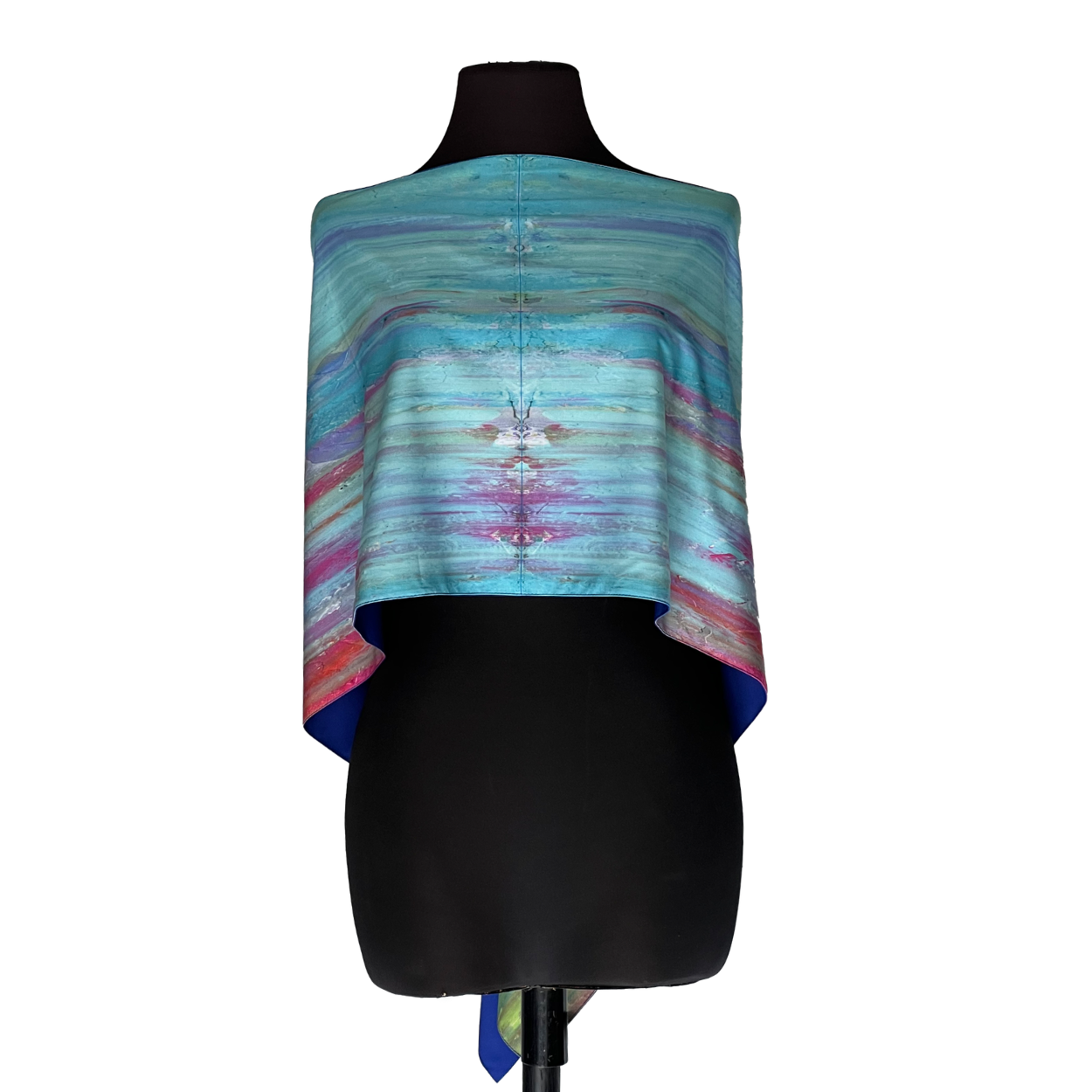 Black mannequin wearing a colorful blue, purple, and pink striped shawl top
