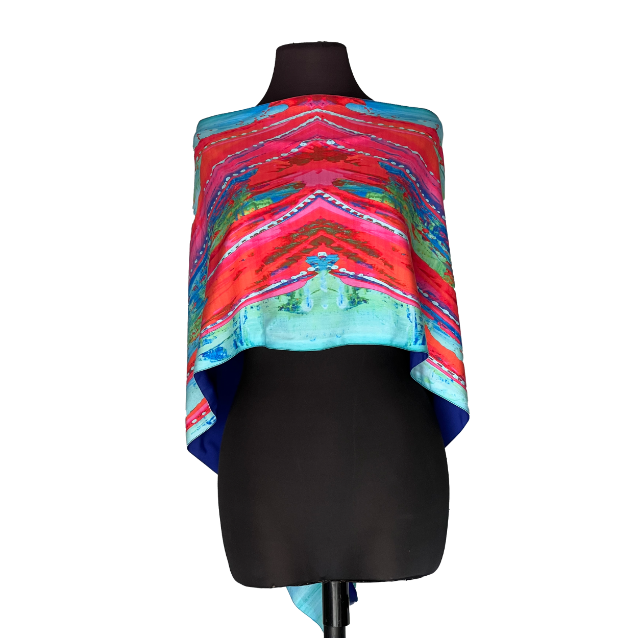 Colorful patterned shawl draped over a black dress form mannequin