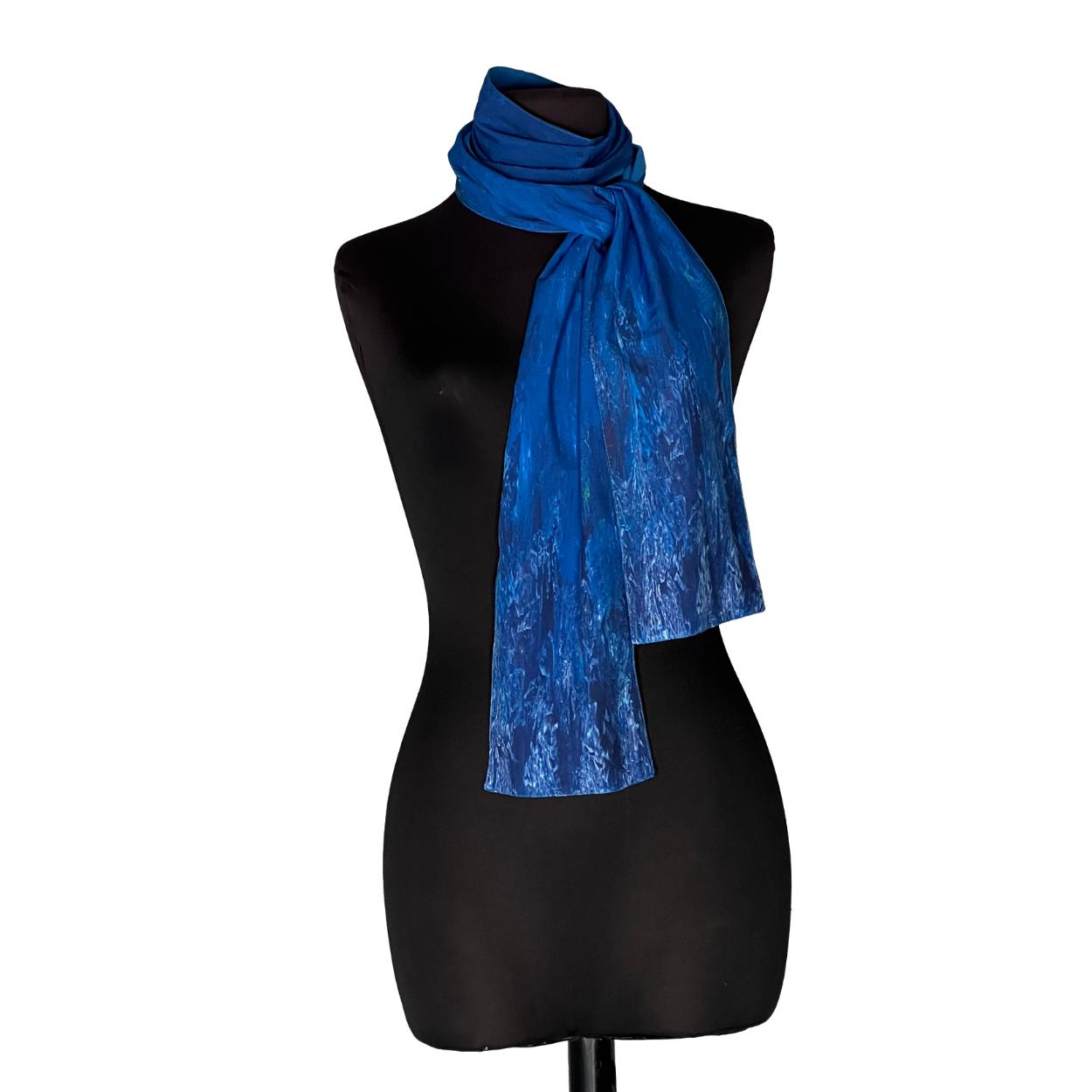 Blue scarf draped around a black mannequin torso on a white background