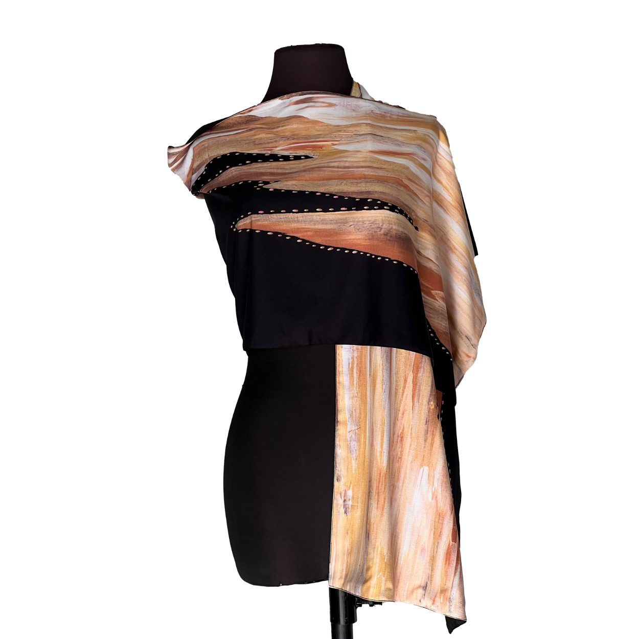 Black mannequin wearing a draped beige-and-brown striped garment with a long front panel