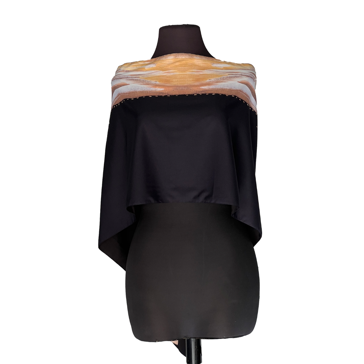 Black dress form displaying an off-shoulder black garment with peach and white scarf-like wrap at the neckline