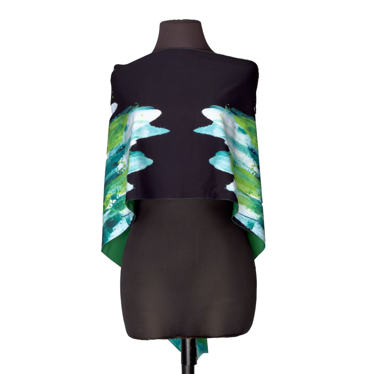 Black dress form wearing a black-and-teal draped garment with green and blue feather-like side panels