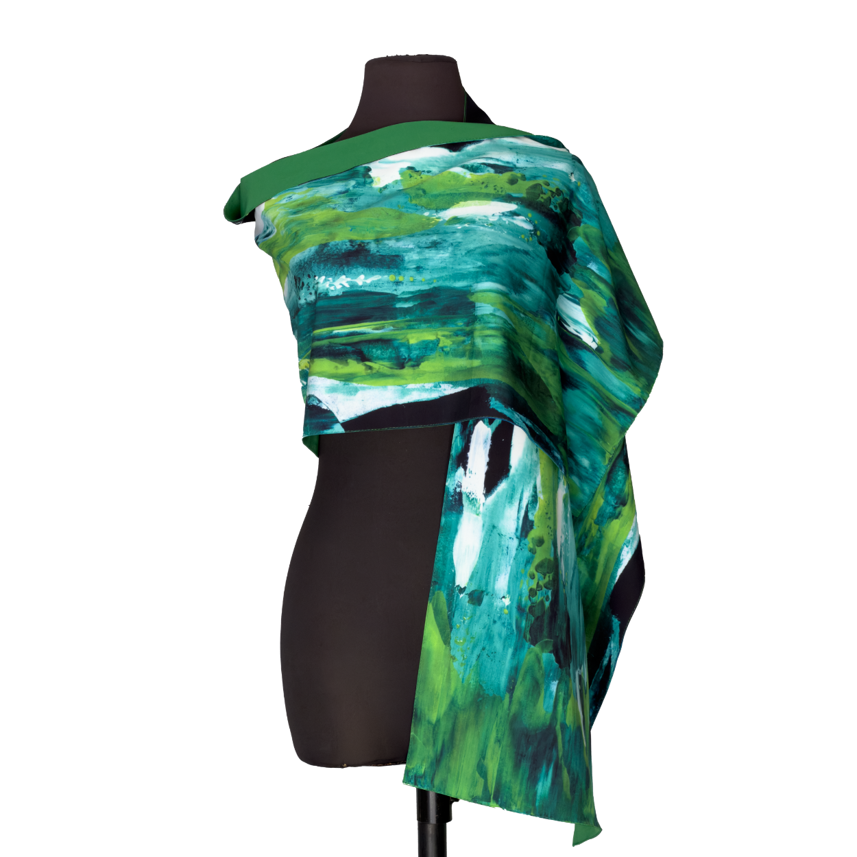 Mannequin wearing a green, blue, and teal abstract-patterned shawl draped over one shoulder