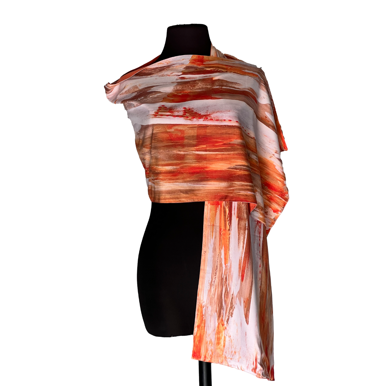 Black dress form wearing a sheer orange, white, and brown striped draped scarf
