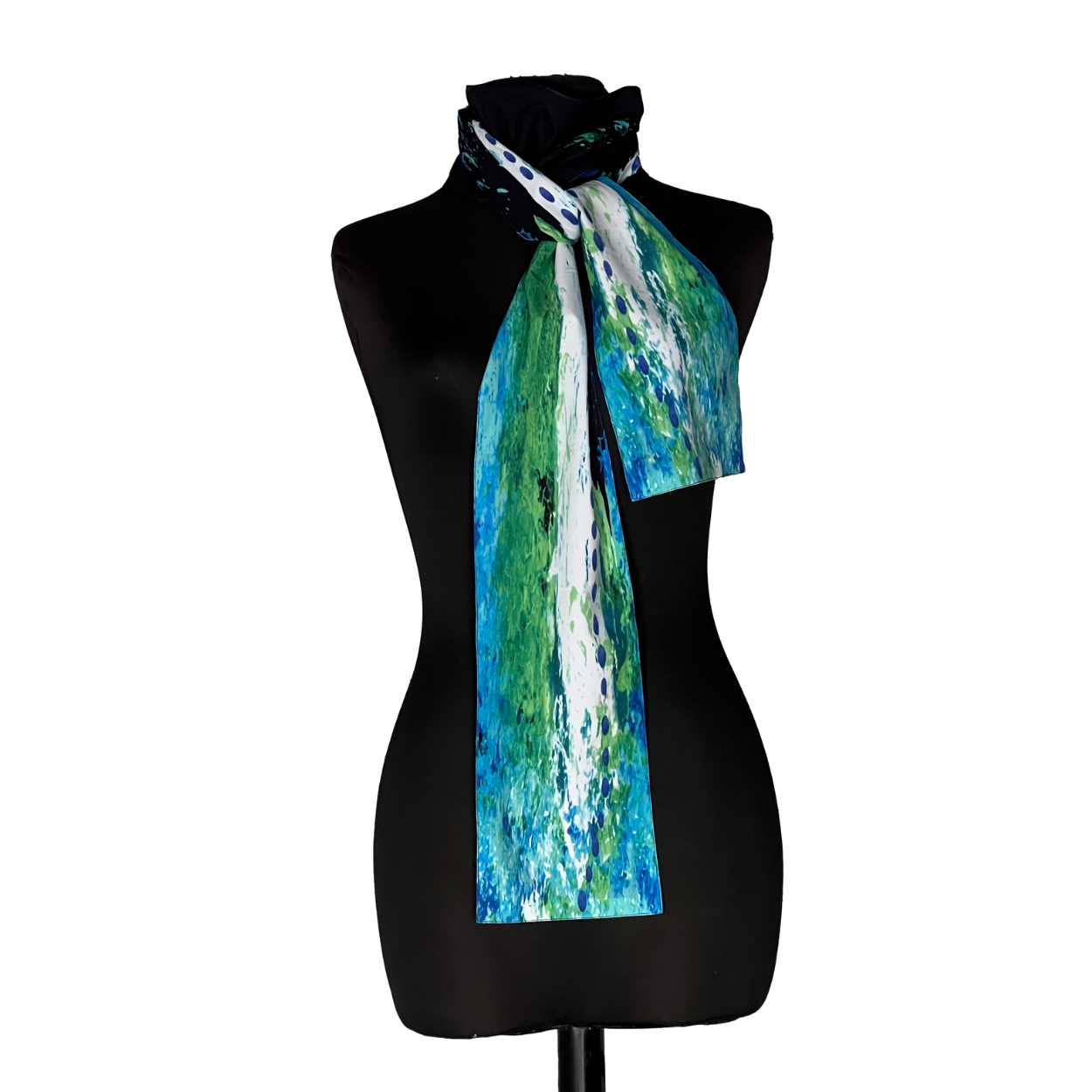 Black dress form wearing a blue, green, and white patterned scarf