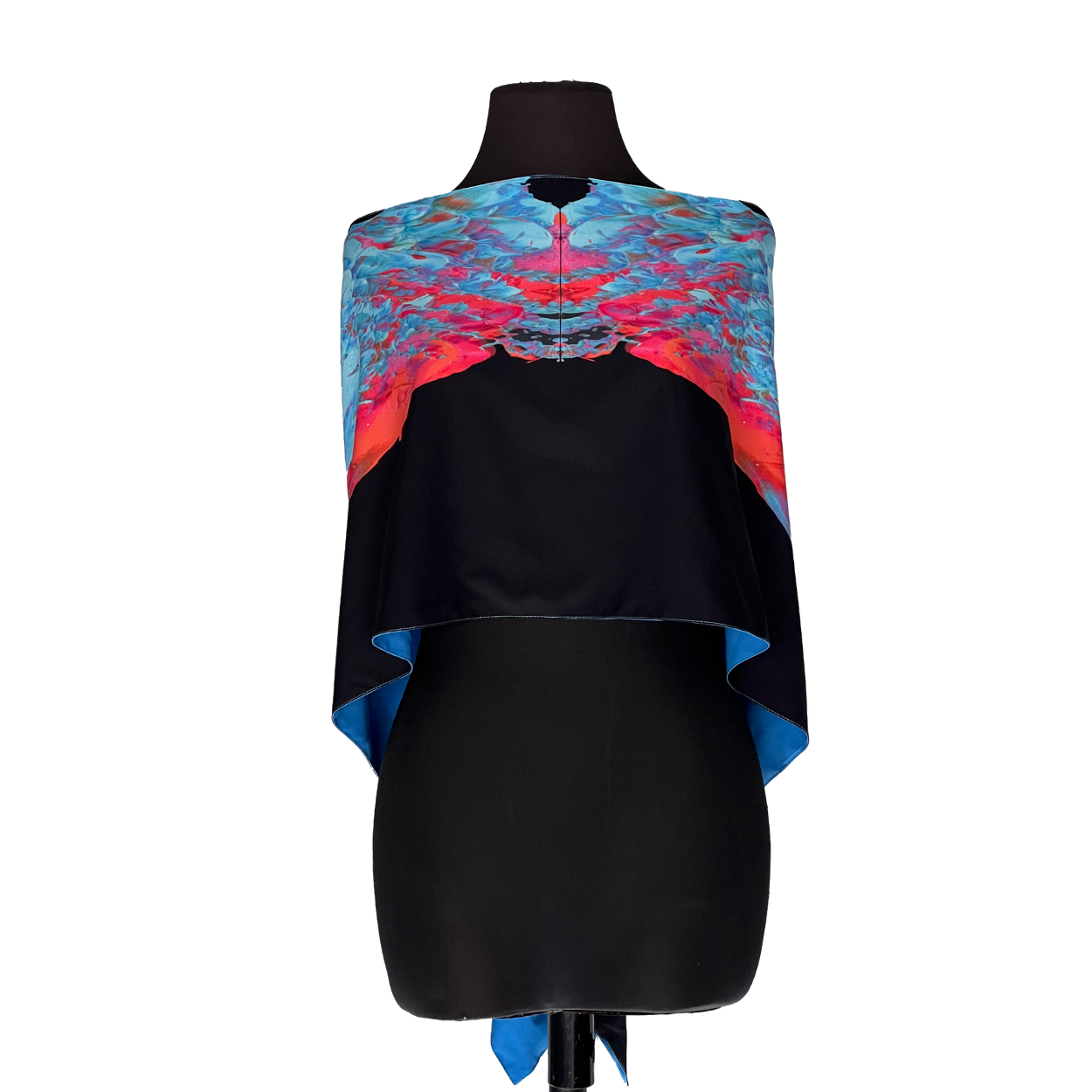Black dress form wearing a colorful blue, pink, and red draped garment with a black center panel