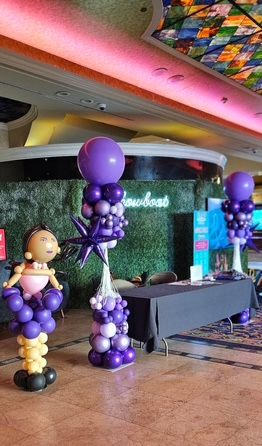 Balloon decor for East Coast Women’s Championship Boxing Tournament at Showboat Casino by My Life In Balloons LLC featuring female boxer sculpture and purple columns.