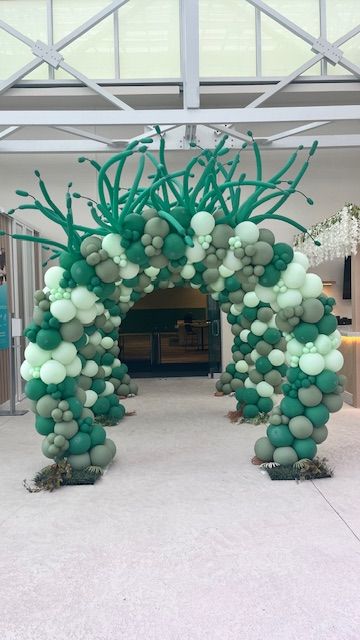 Green organic prom balloon arch with grass-tip extensions by My Life In Balloons LLC for a 2024 event at Showboat, Atlantic City.