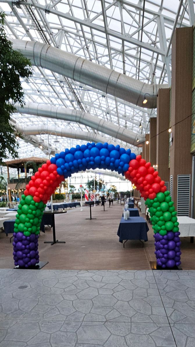 Multi-colored balloon arch created by My Life In Balloons LLC for the Let’s Get Cookin’ 25 corporate event at Showboat Casino in Atlantic City. Features vibrant red, green, blue, and purple specialty balloons.