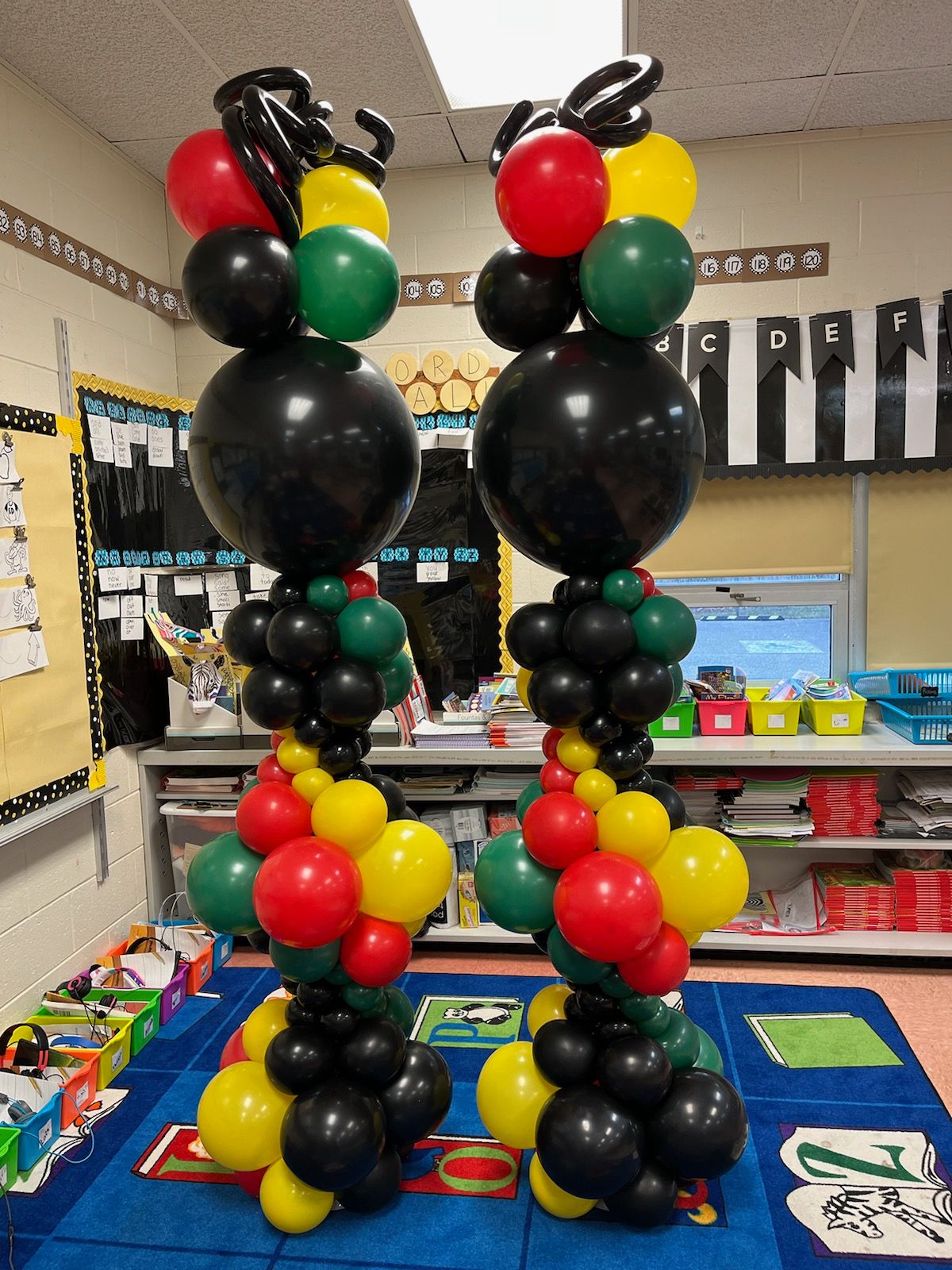 Balloon columns in red, yellow, green, and black by My Life In Balloons LLC for a Pan-African themed classroom celebration.