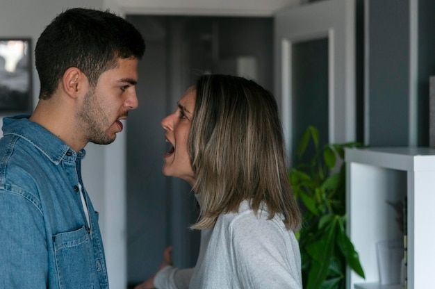 A man and a woman are having an argument in a living room.