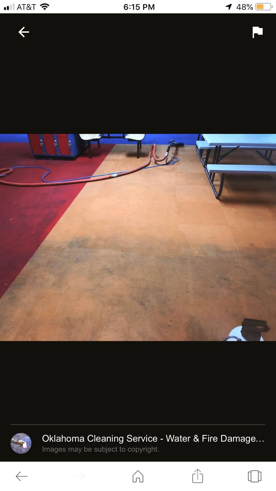 Orange and red floor in a room with tables and a machine.