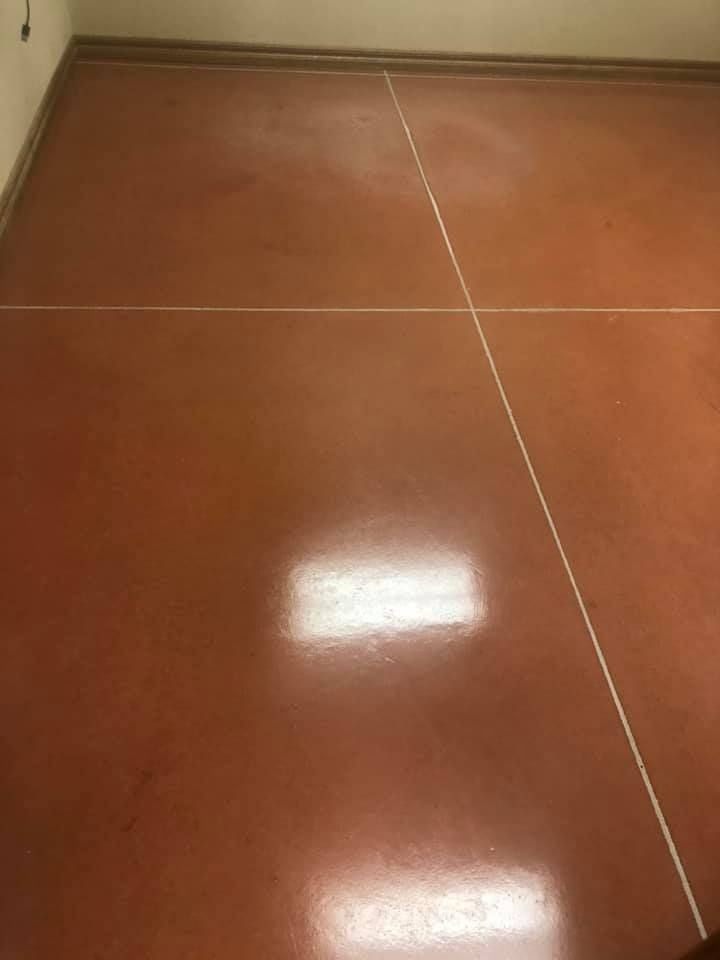 Red floor with white lines, likely a sports court or similar.