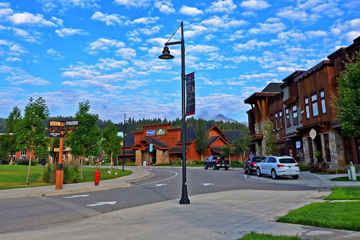 A street with cars parked on the side of it and a fire hydrant.