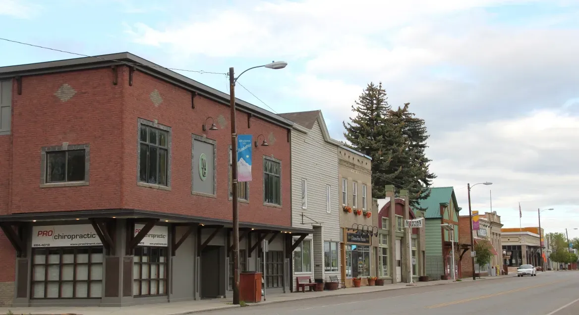 A row of buildings are lined up on the side of a street.