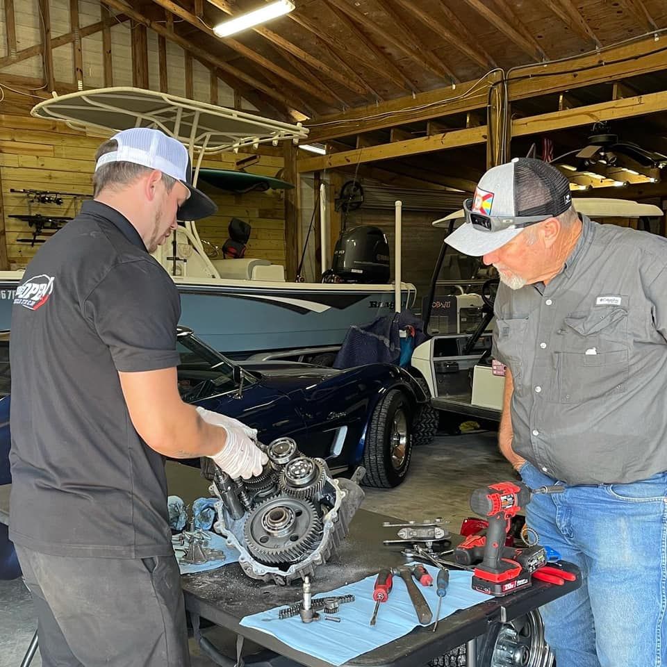 Two men are working on a car engine in a garage — St. Augustine, FL — Wide Open Mobile Tech