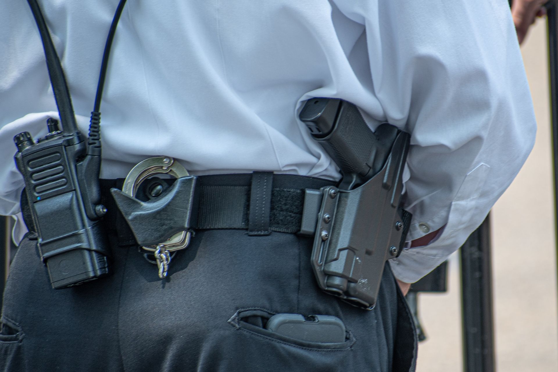 Armed security guard featuring a vigilant guard in uniform holding a firearm outdoors. Armed security guard featuring a vigilant guard in uniform holding a firearm outdoors.