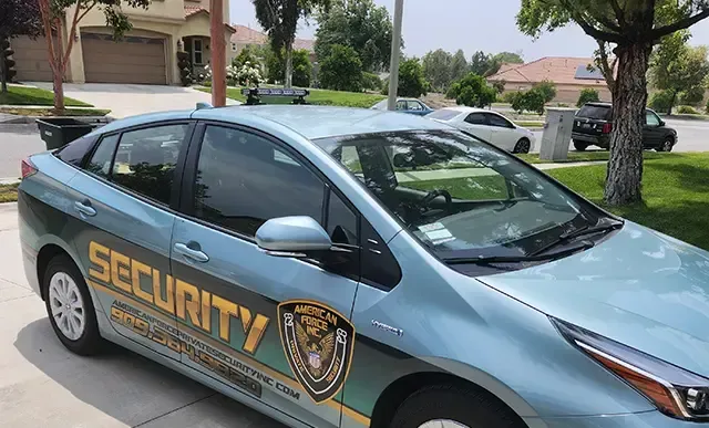 A security car is parked in front of a house