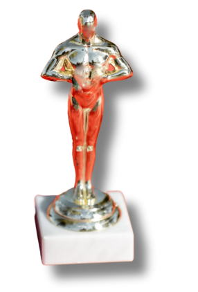 A silver and red oscar statue on a white base