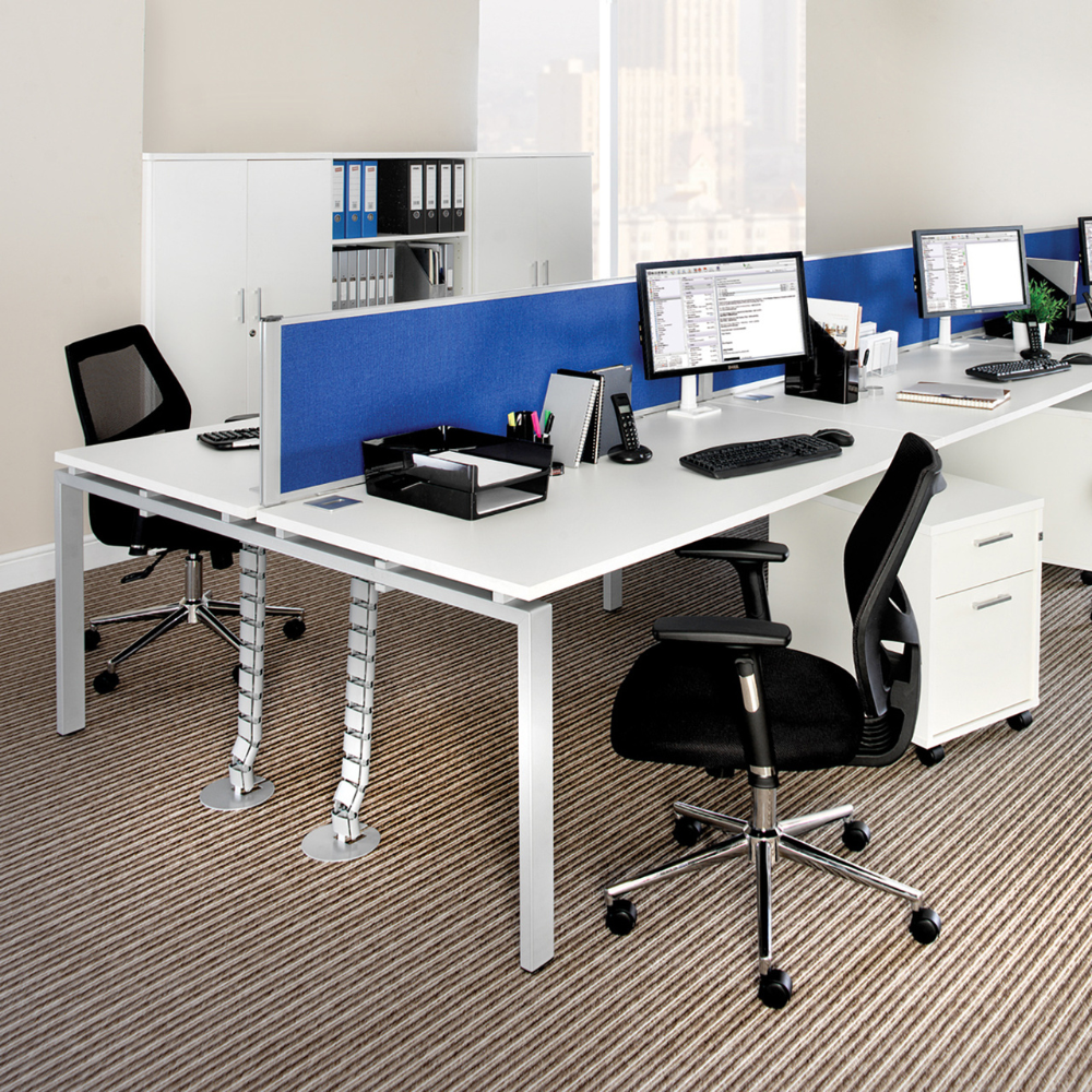 a cubicle in an office with a blue divider between two desks