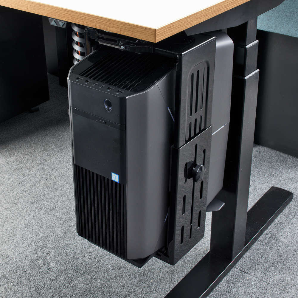a computer tower is mounted under a desk
