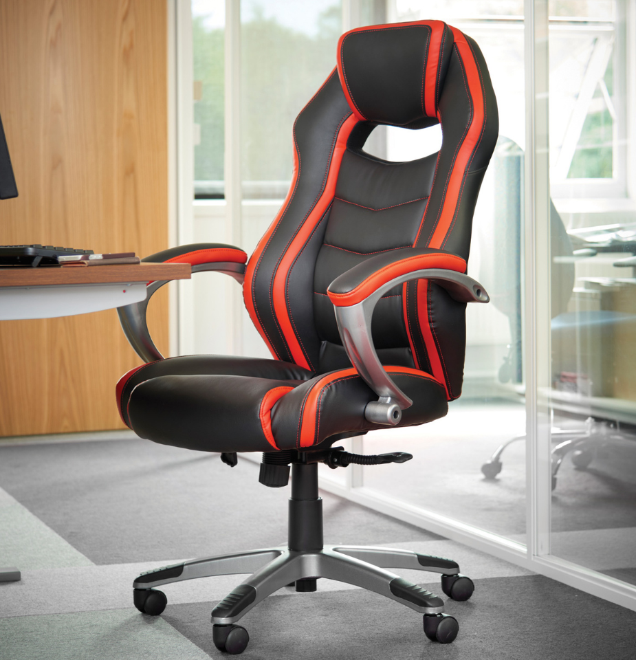 a black and red office chair sits in front of a computer desk