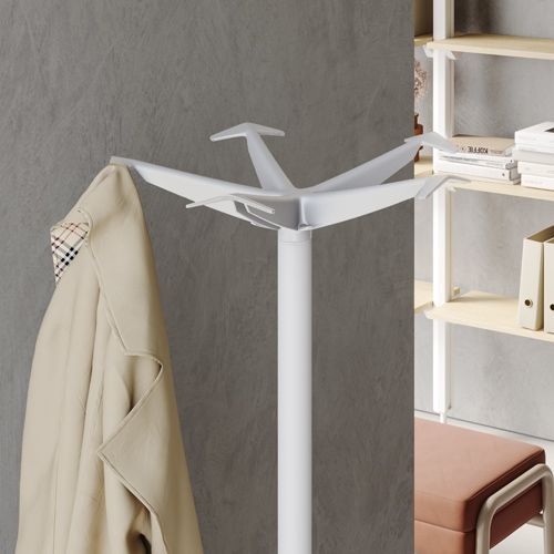 a white coat rack with a coat hanging on it