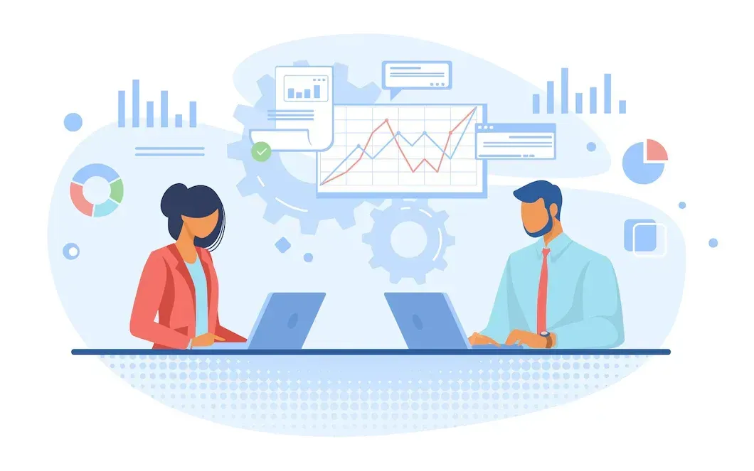 A man and a woman are sitting at a table with laptops.