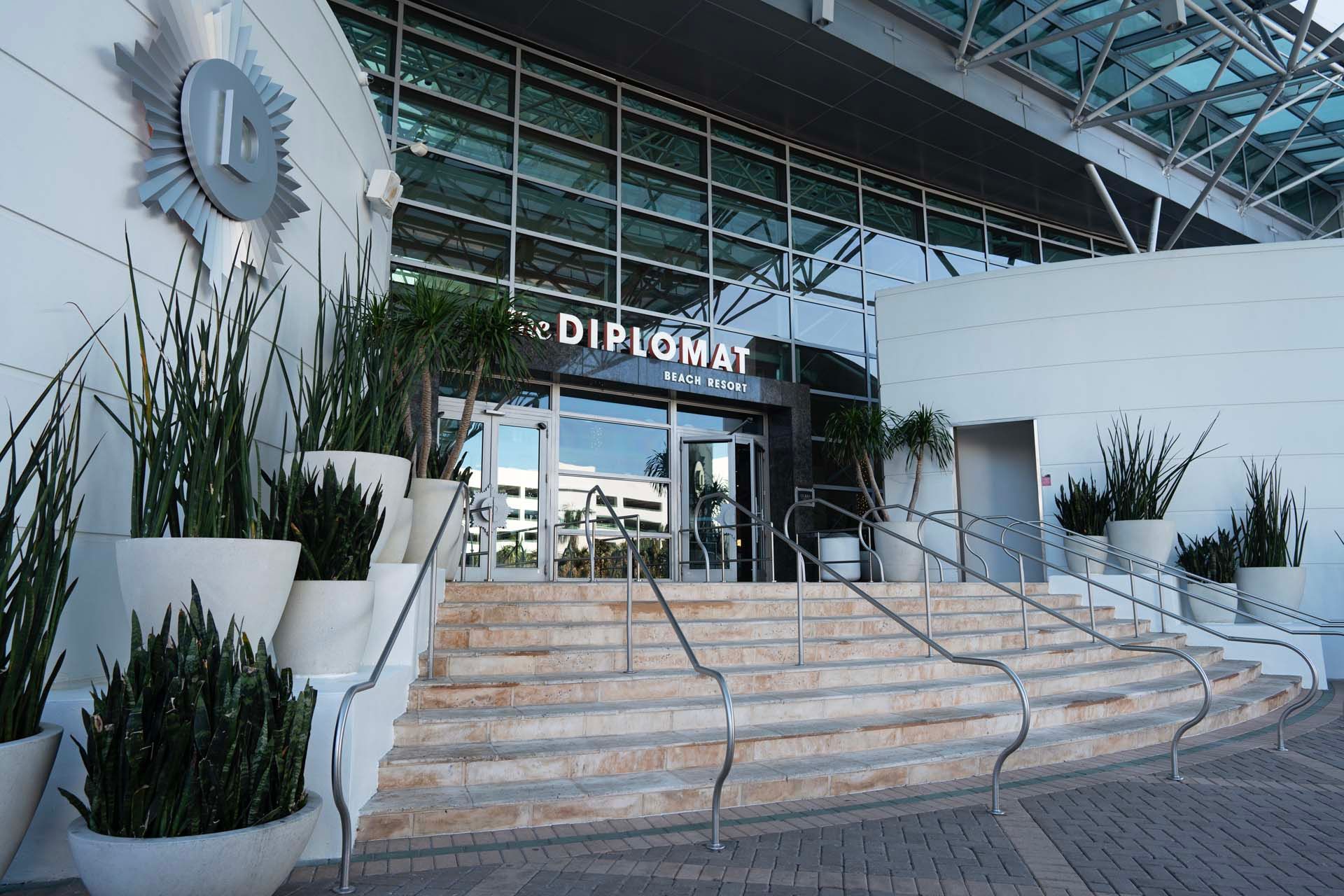 A large building with stairs leading up to it and a sign that says diplomat