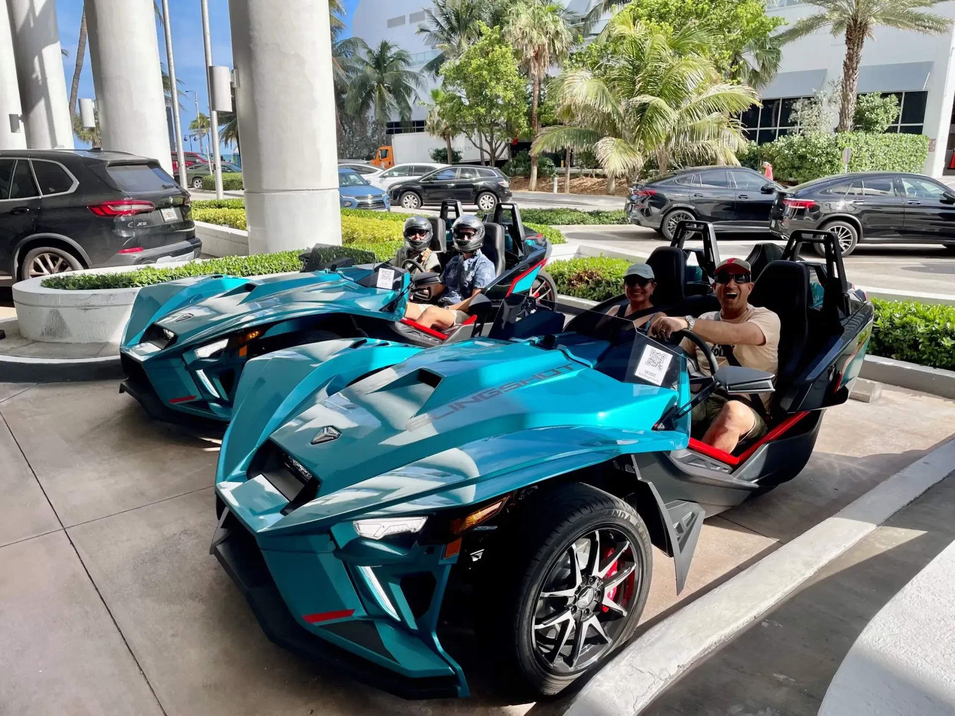 A group of people are riding a slingshot in a parking lot.