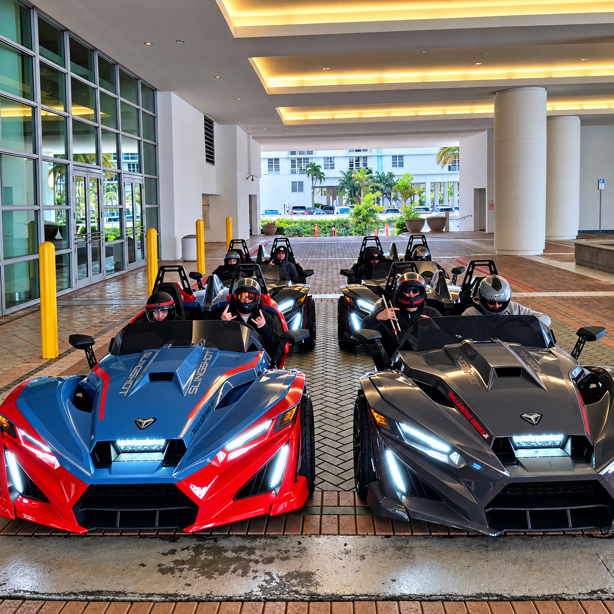 Red and black Polaris Slingshots lined up with riders aboard.