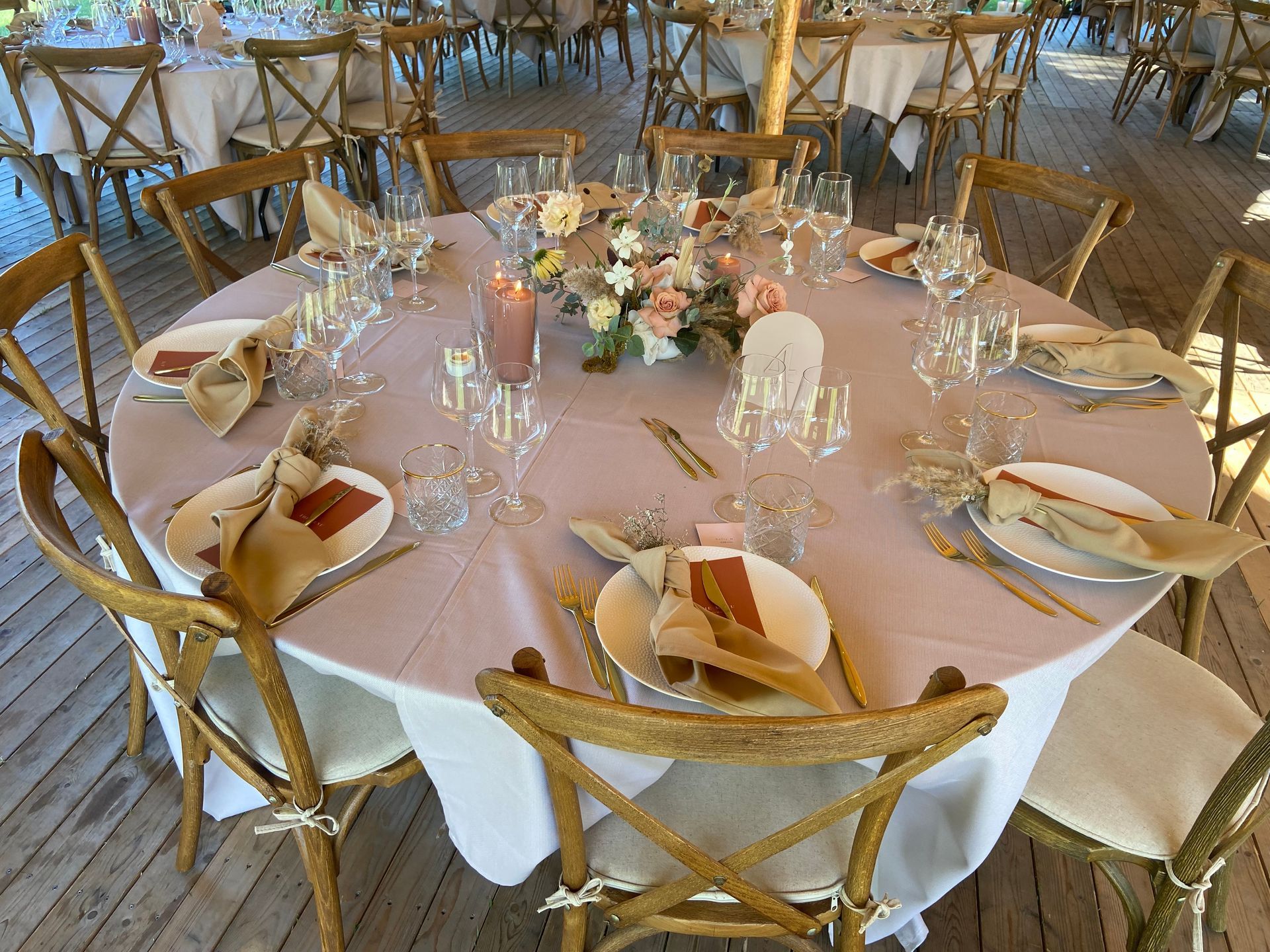 ronde tafel met wit tafelkleed en witte borden en olijfkleur servetten