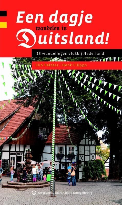 Cover of travel guide "Een dagje in Duitsland!" with German flag. Colorful village scene.